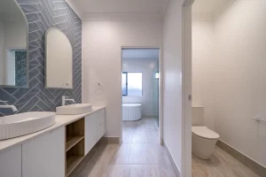Powder room with separate toilet and bathroom, feature walls and custom dual vanity
